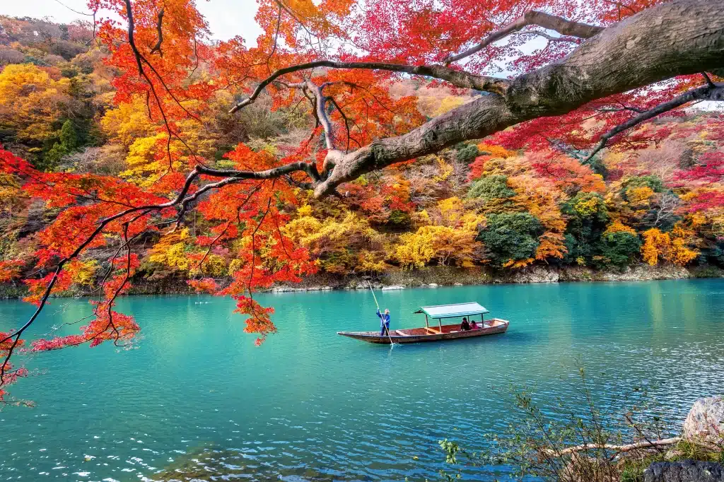 boatman punting boat river arashiyama autumn season along river kyoto japan