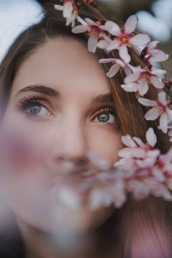 young woman near tree twig with flowers 2021 11 29 06 57 06 utc