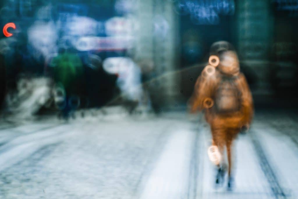 Blurred picture of person walking along the street